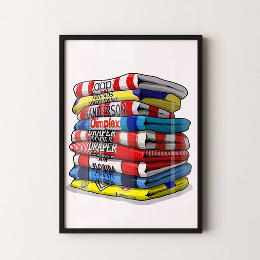 A framed illustration of a stack of colorful towels with various text printed on them.
