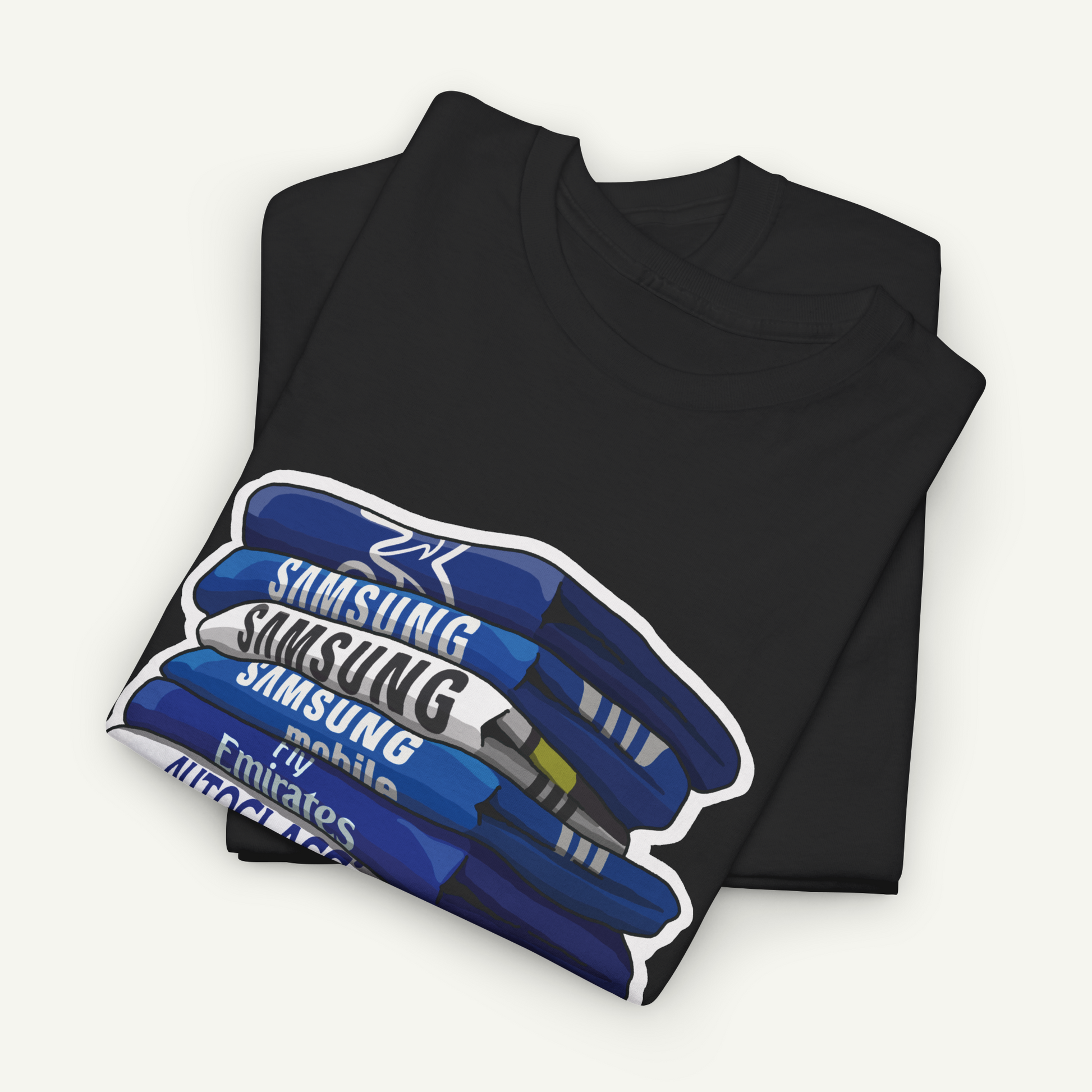 A black t-shirt with a graphic design depicting a stack of blue books with the text "Samsung Mobile" printed on them.