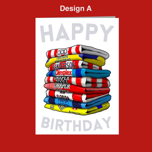 A stack of colorful towels with the text "Happy Birthday" written on them, set against a red background.
