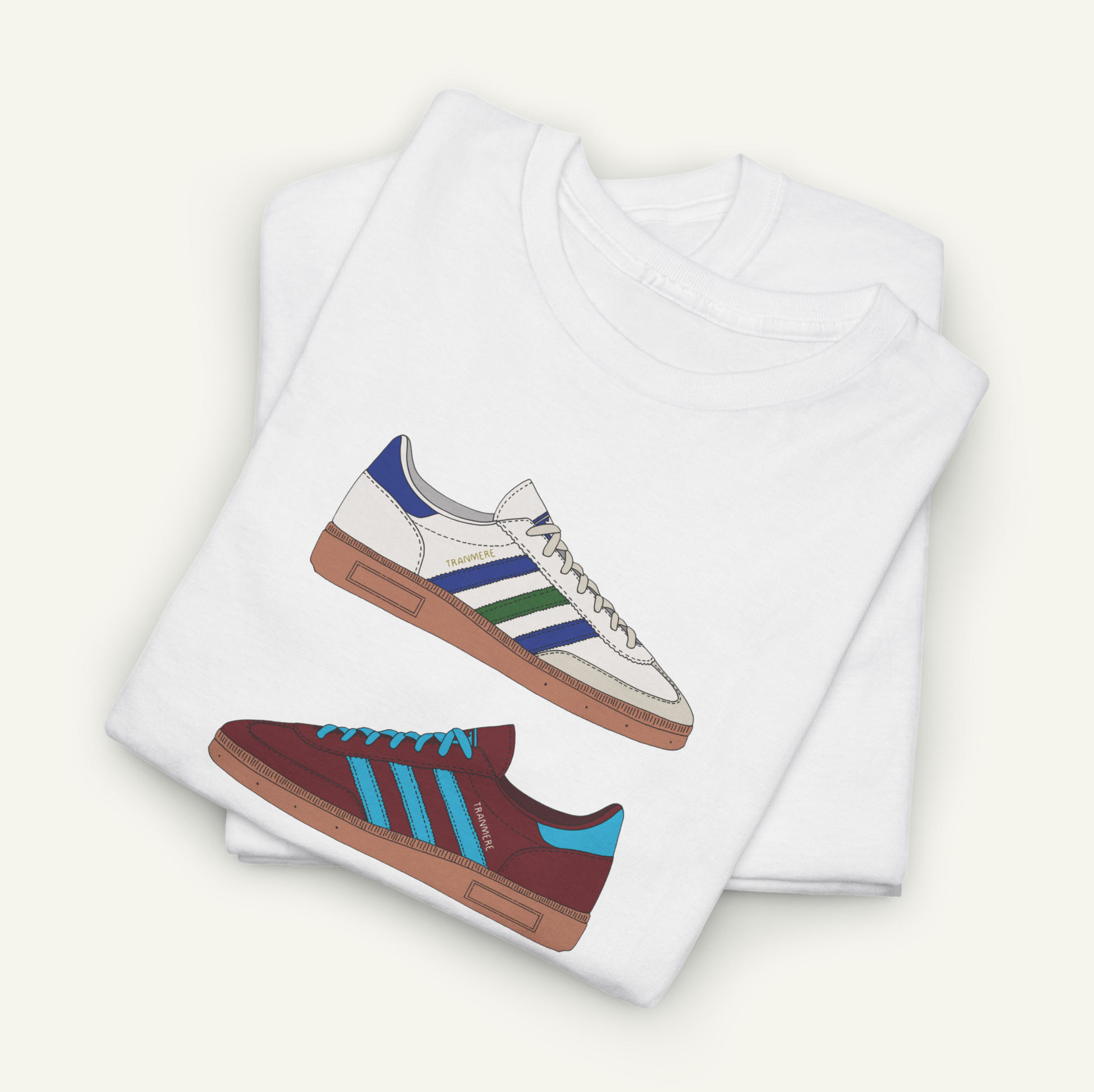 A white t-shirt with a graphic design of two different colored Adidas sneakers.