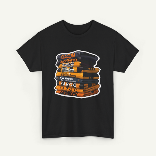 A black t-shirt with a graphic design depicting a stack of books or magazines with various text and logos printed on them.