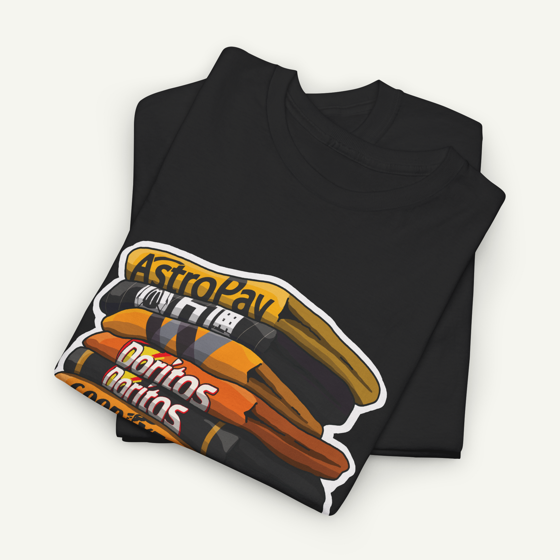 A black t-shirt with a graphic design featuring stacked orange and black objects, along with the text "AstroPay Doritos" printed on it.