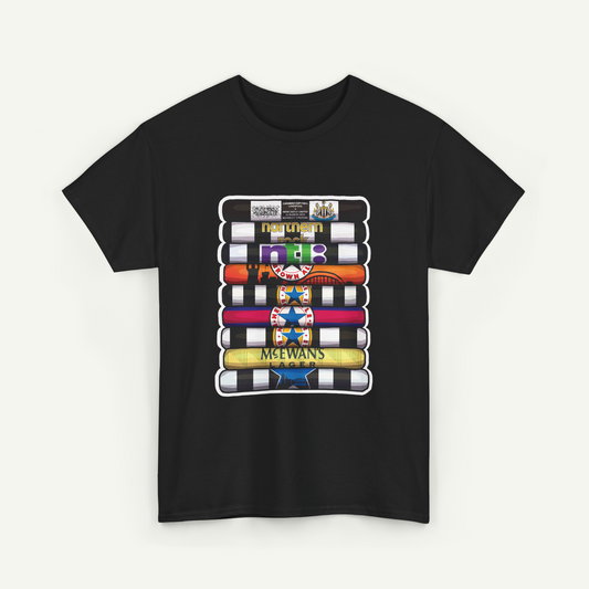 A black t-shirt with a graphic design featuring a stack of colorful video tapes or cassette tapes, along with various logos and text.