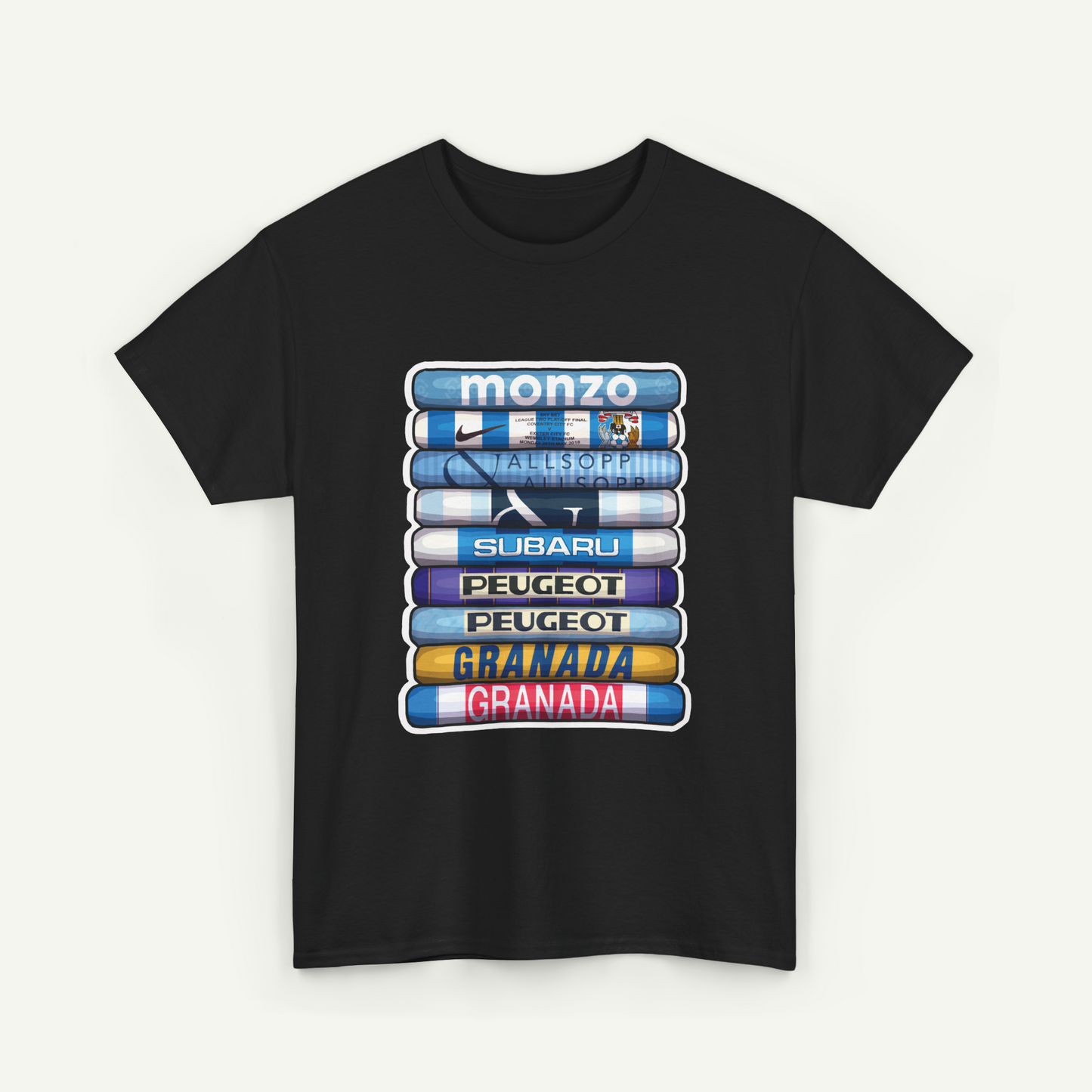 A black t-shirt with a graphic design featuring a stack of seven different colored books or magazines, each with a different logo or brand name printed on the cover.