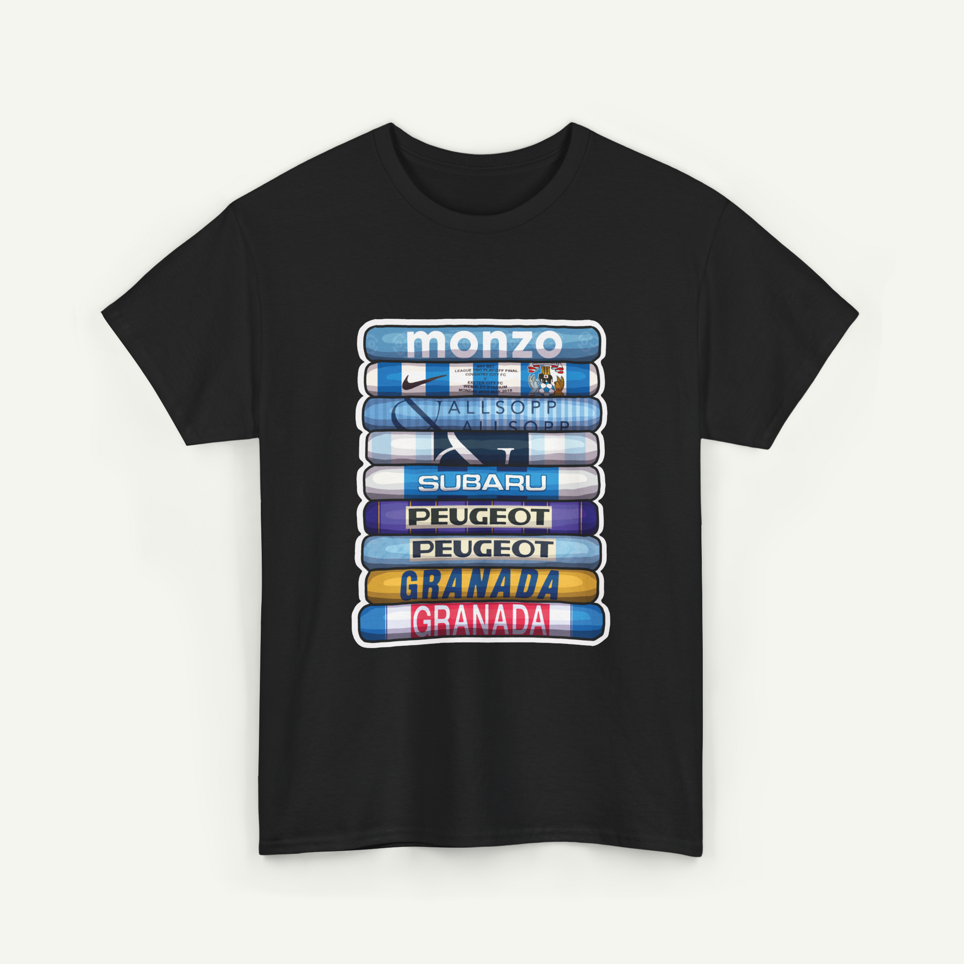 A black t-shirt with a graphic design featuring a stack of seven different colored books or magazines, each with a different logo or brand name printed on the cover.