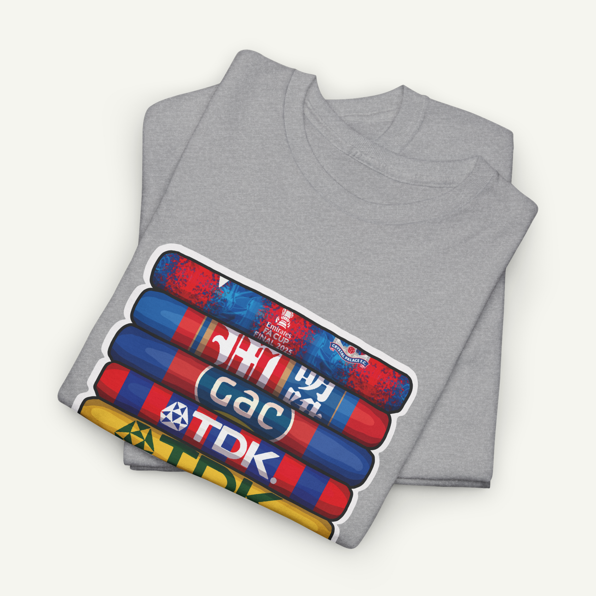 A gray t-shirt with a graphic design depicting a stack of colorful tubes or bottles, each with a different logo or text on it.
