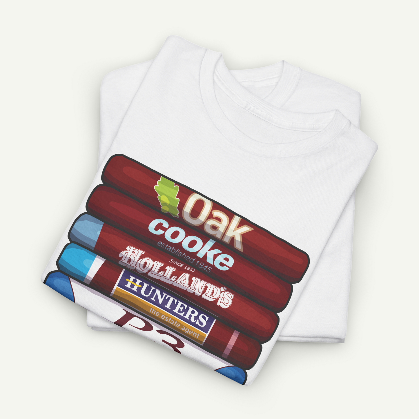 A white t-shirt with a graphic design featuring a stack of colorful pencils with the text "OAK cook" printed on them.
