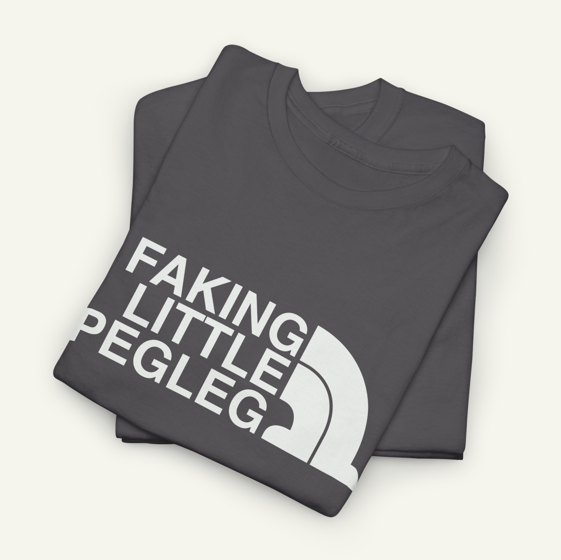 A gray t-shirt with the text "FAKING LITTLE PEGLEG" printed on it.