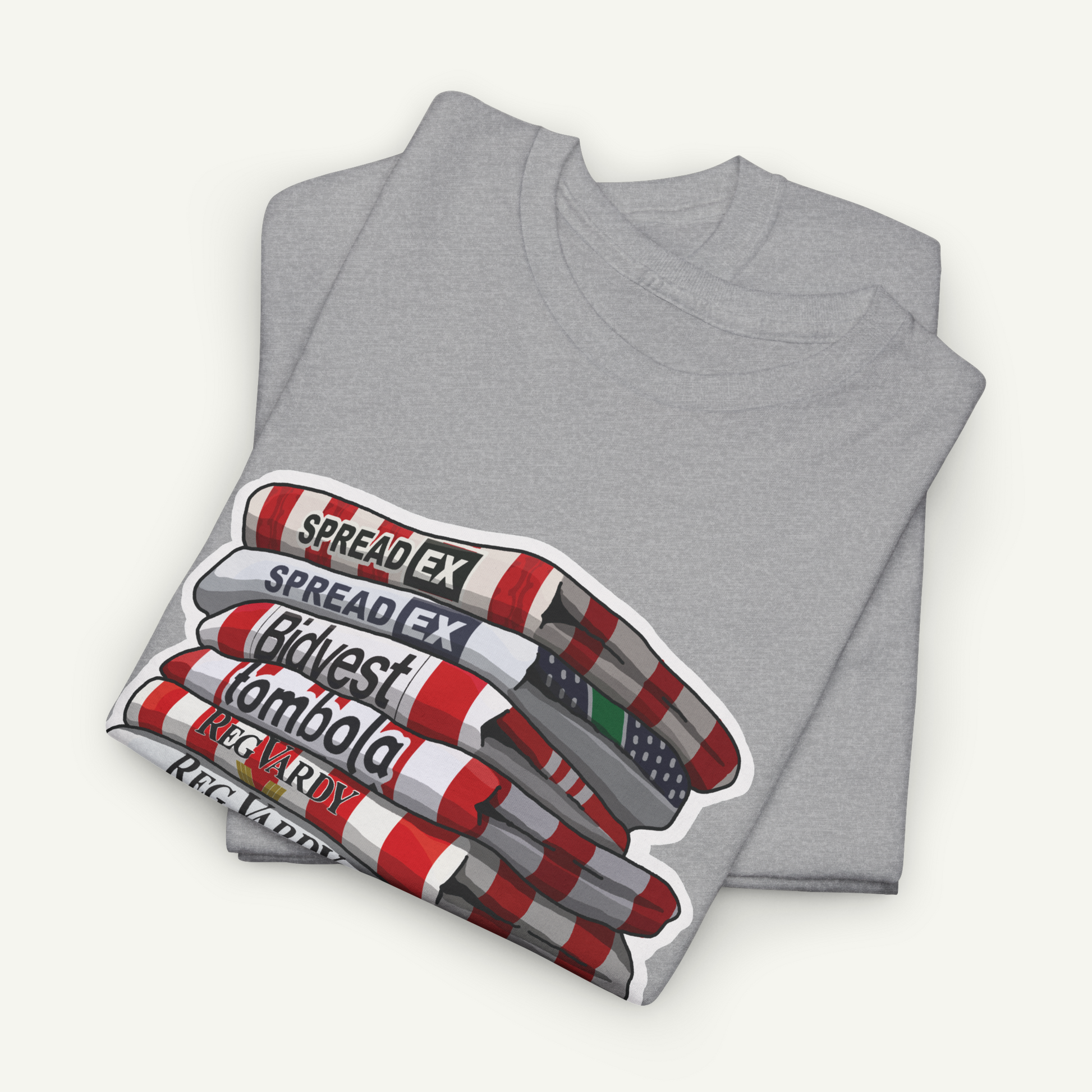 A gray t-shirt with a graphic design depicting a stack of books or magazines with the text "SPREAD EX" printed on them.