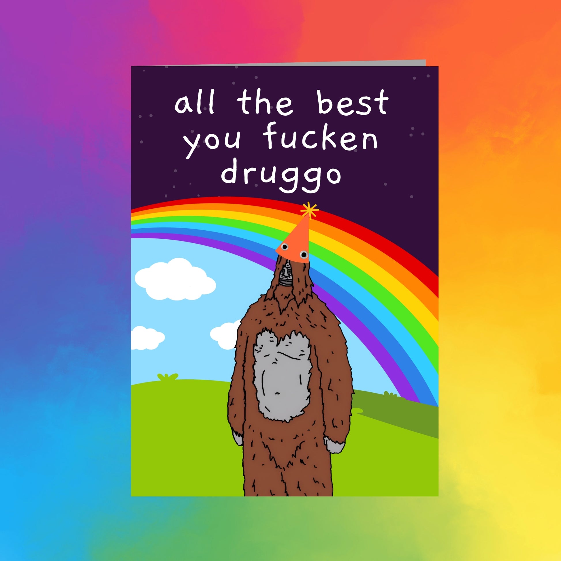 a cartoon depiction of a brown bear wearing a party hat and standing in a grassy field with a rainbow in the background.