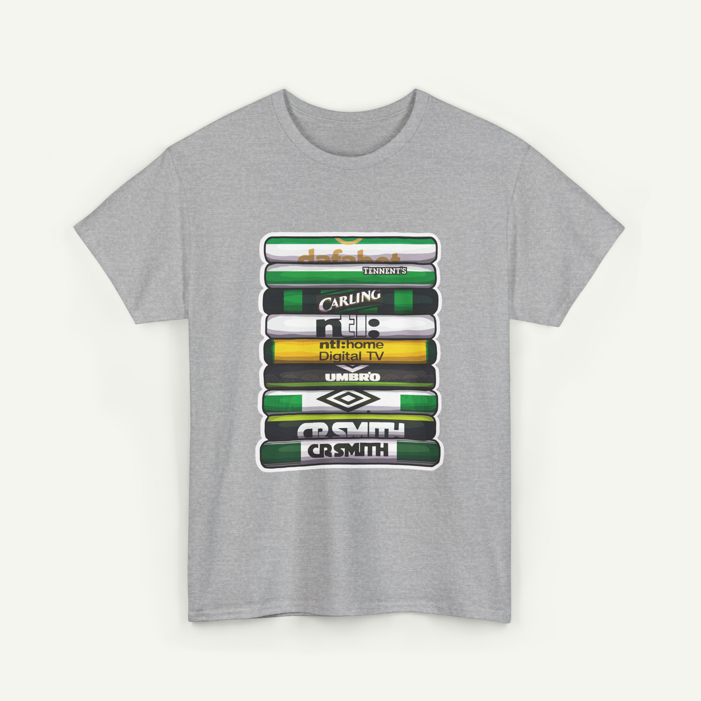 A gray t-shirt with a graphic design featuring a stack of colorful books or magazines with various text and logos printed on them.