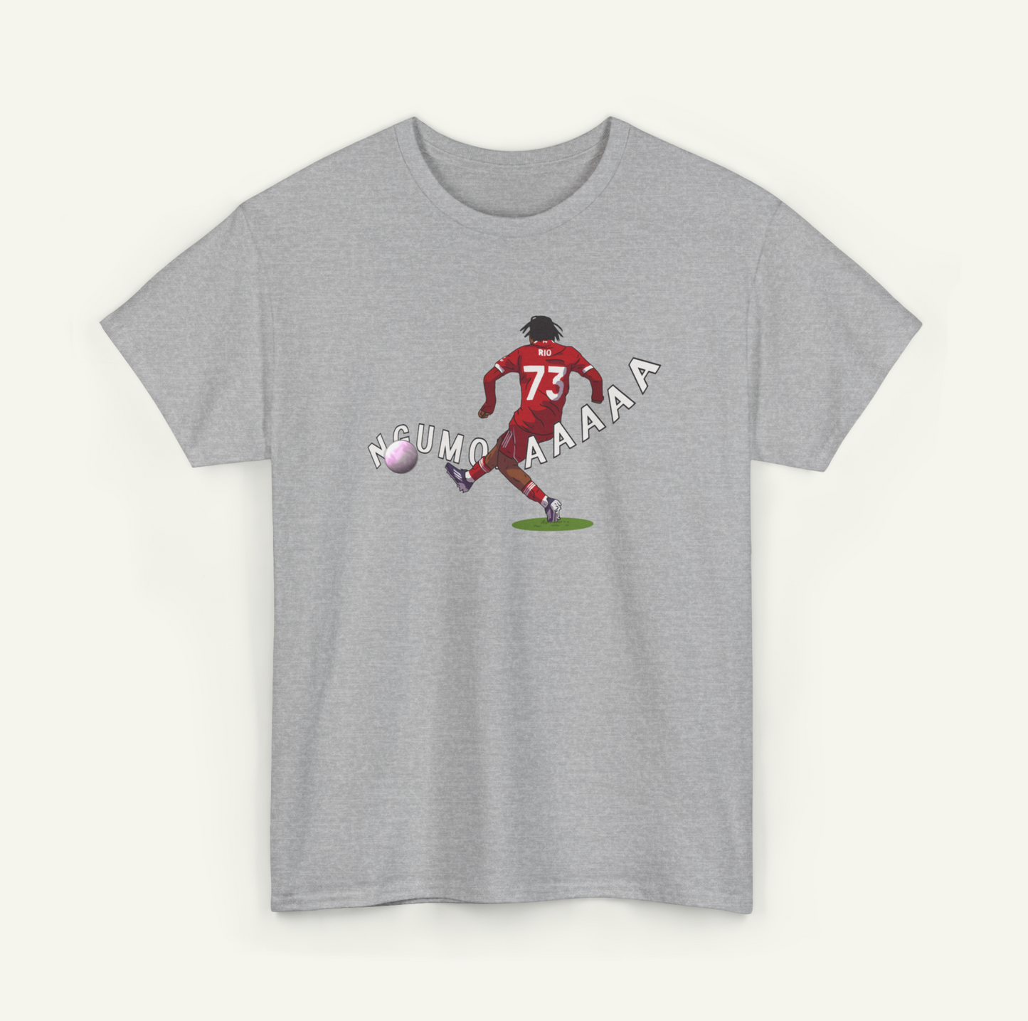 A gray t-shirt with a graphic design depicting a soccer player kicking a ball, accompanied by the text "NCUMO AAAA" in a playful, humorous manner.