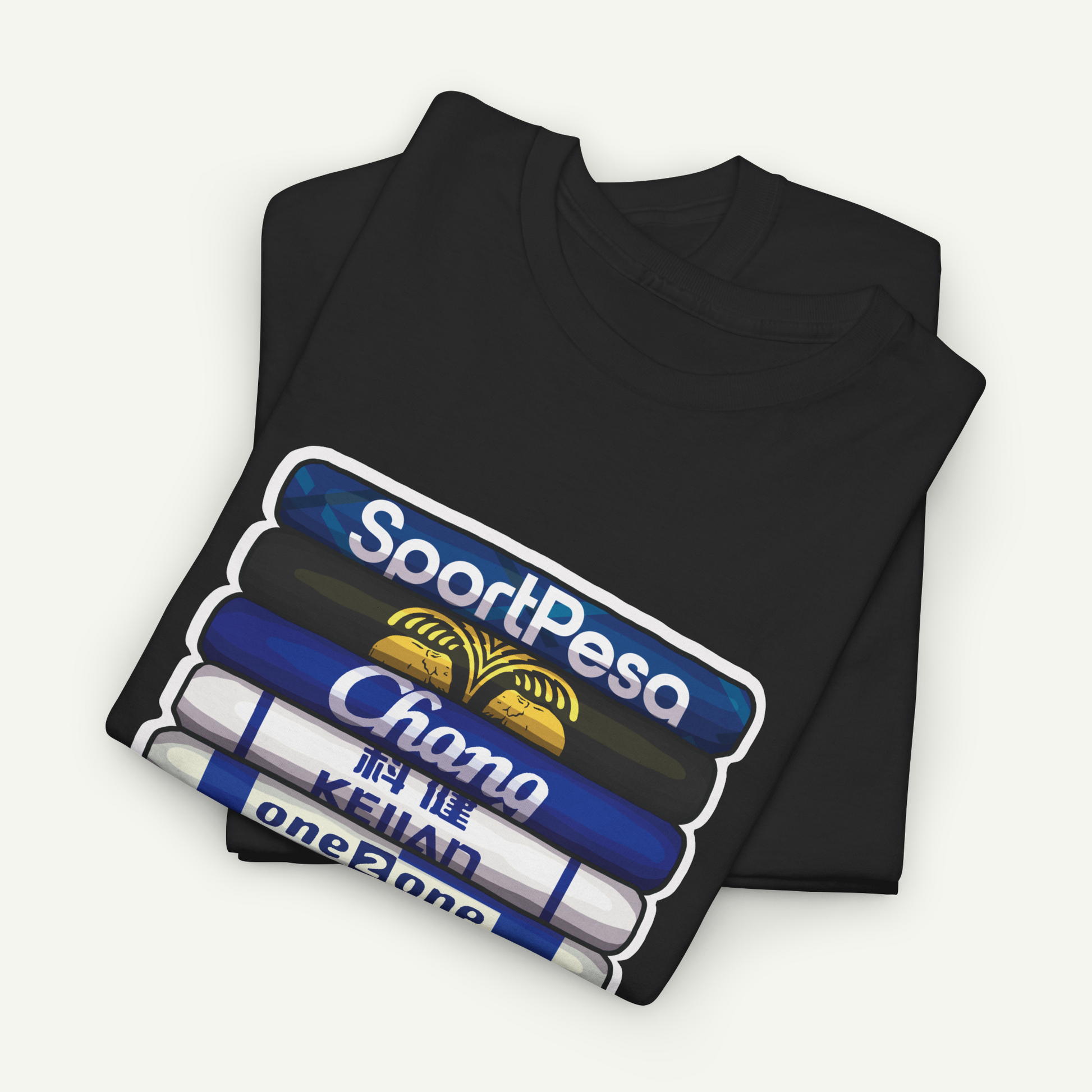 A black t-shirt with a graphic design depicting a stack of books or magazines with the text "SportPesa Chana KeiAD oneZONE" printed on it.