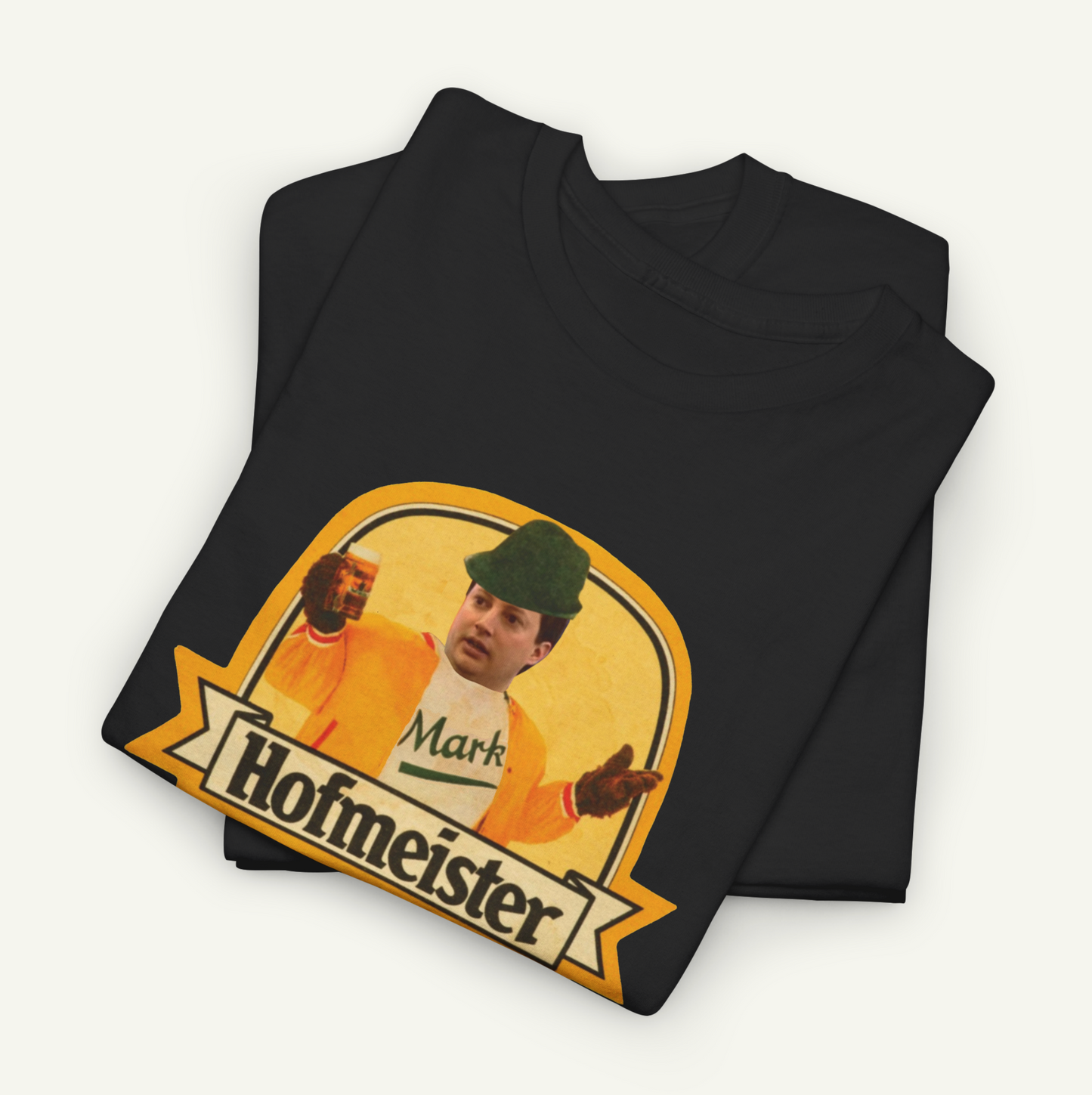 A black t-shirt with a graphic design featuring a man wearing a hat and holding a beer. The text below the graphic says "Hofmeister".