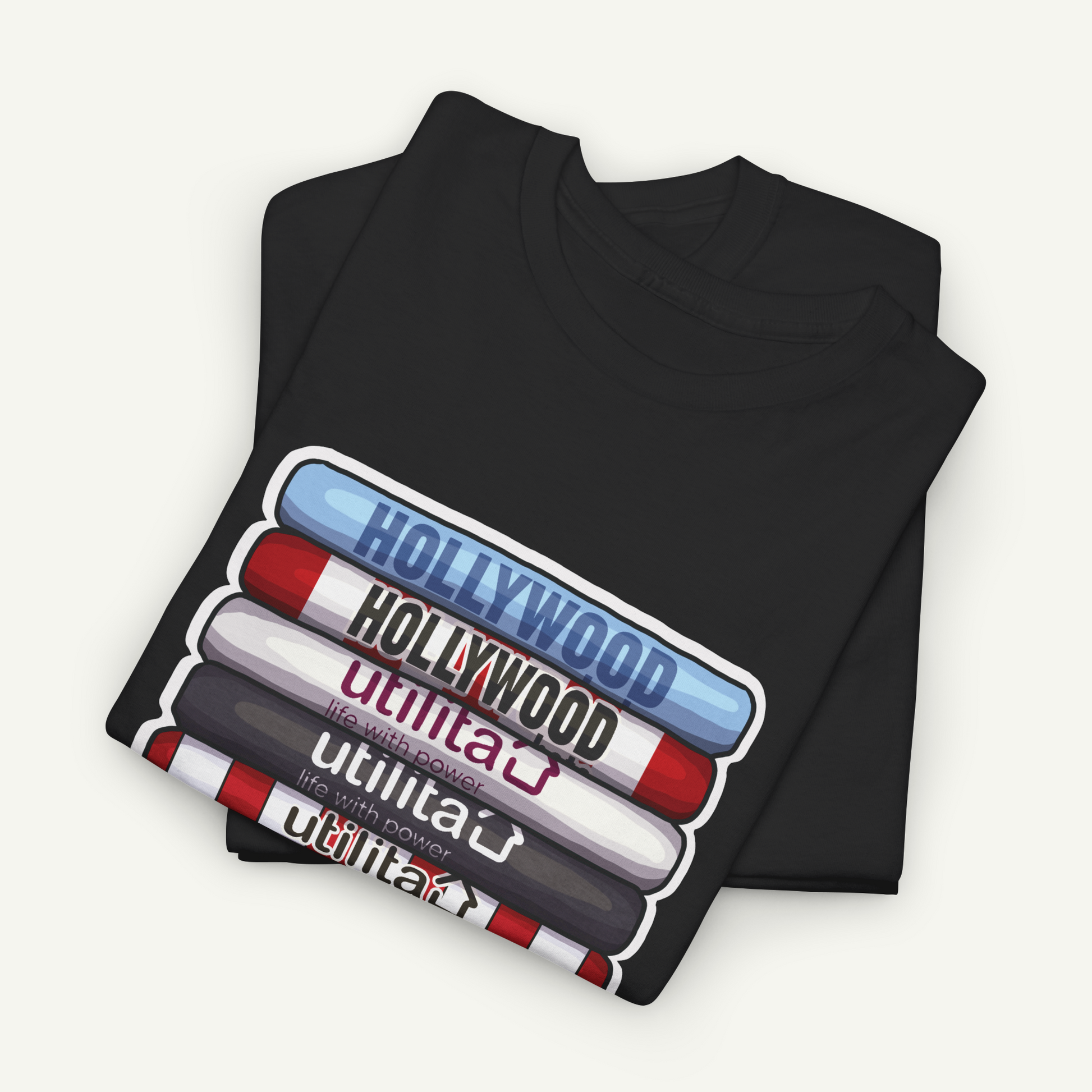 A black t-shirt with a graphic design depicting the words "Hollywood" in various colors, including red, blue, and white, arranged in a stacked formation.