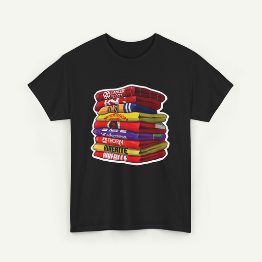 A black t-shirt with a graphic design depicting a stack of colorful towels or blankets.