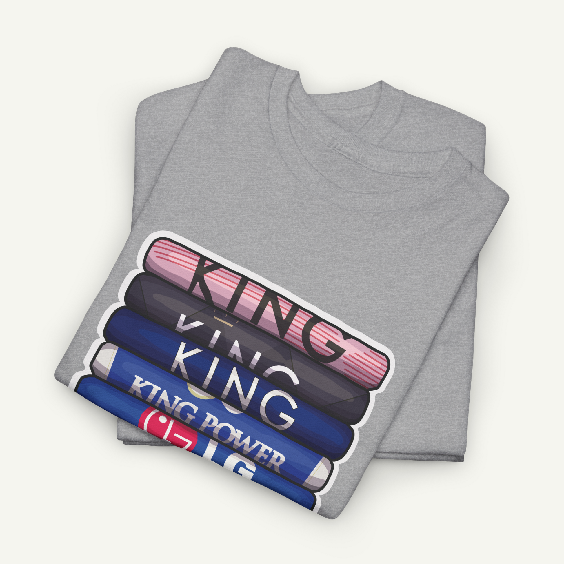 A gray t-shirt with a graphic design featuring the text "KING" in a stacked format, with each word in a different color.