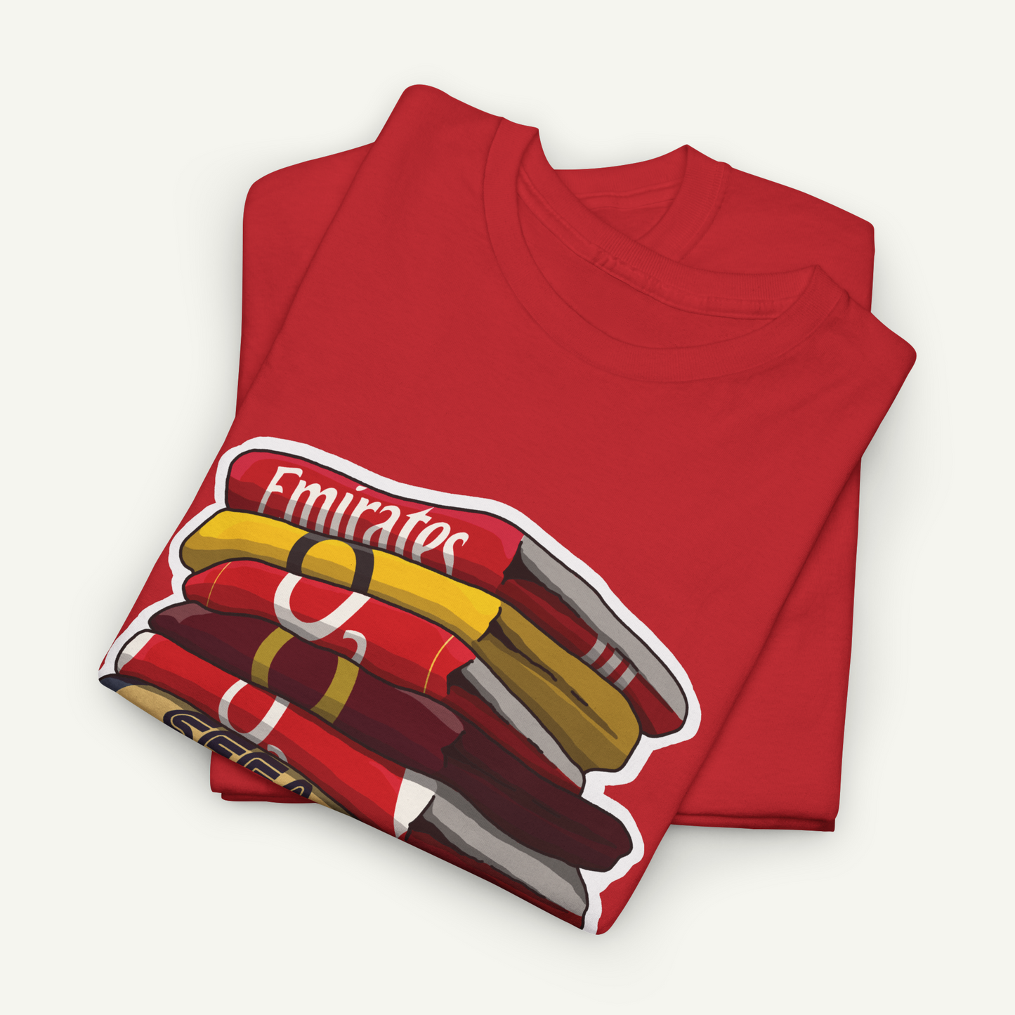 A red t-shirt with a graphic design depicting a stack of books or magazines.