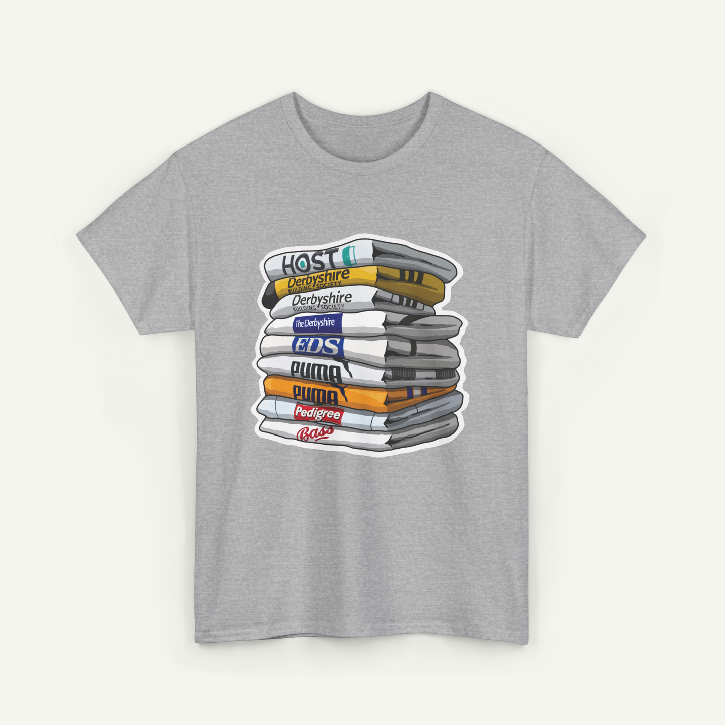 A gray t-shirt with a graphic design depicting a stack of various colored books or magazines.