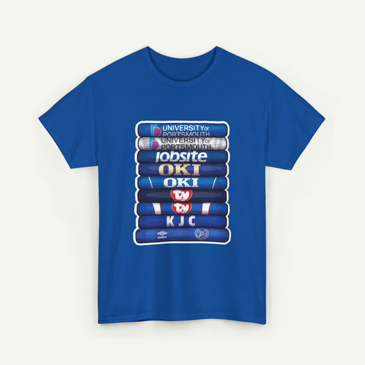 A blue t-shirt with a graphic design featuring a stack of books with various logos and text on the spines.
