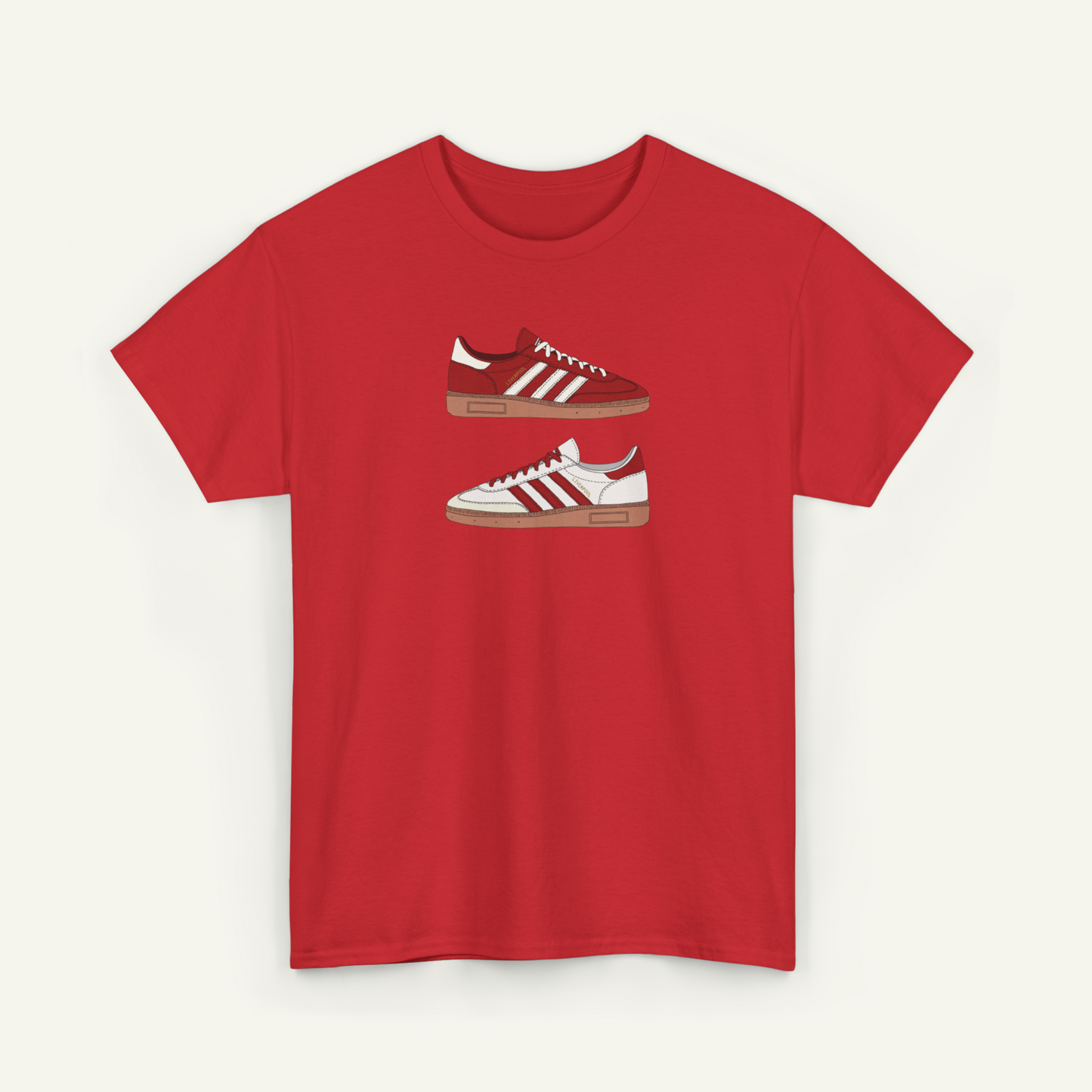 A red t-shirt with a graphic design of two Adidas sneakers on it.