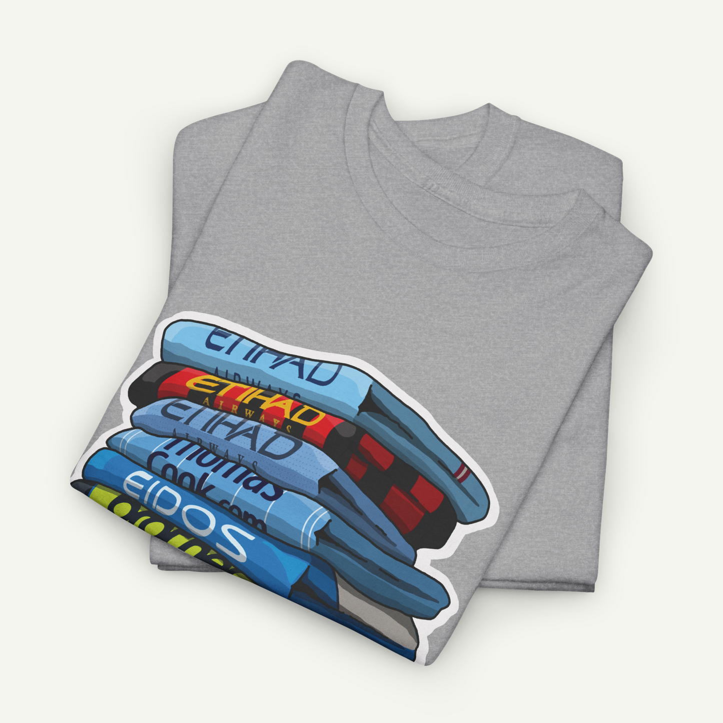 A gray t-shirt with a graphic design depicting a stack of books or magazines.