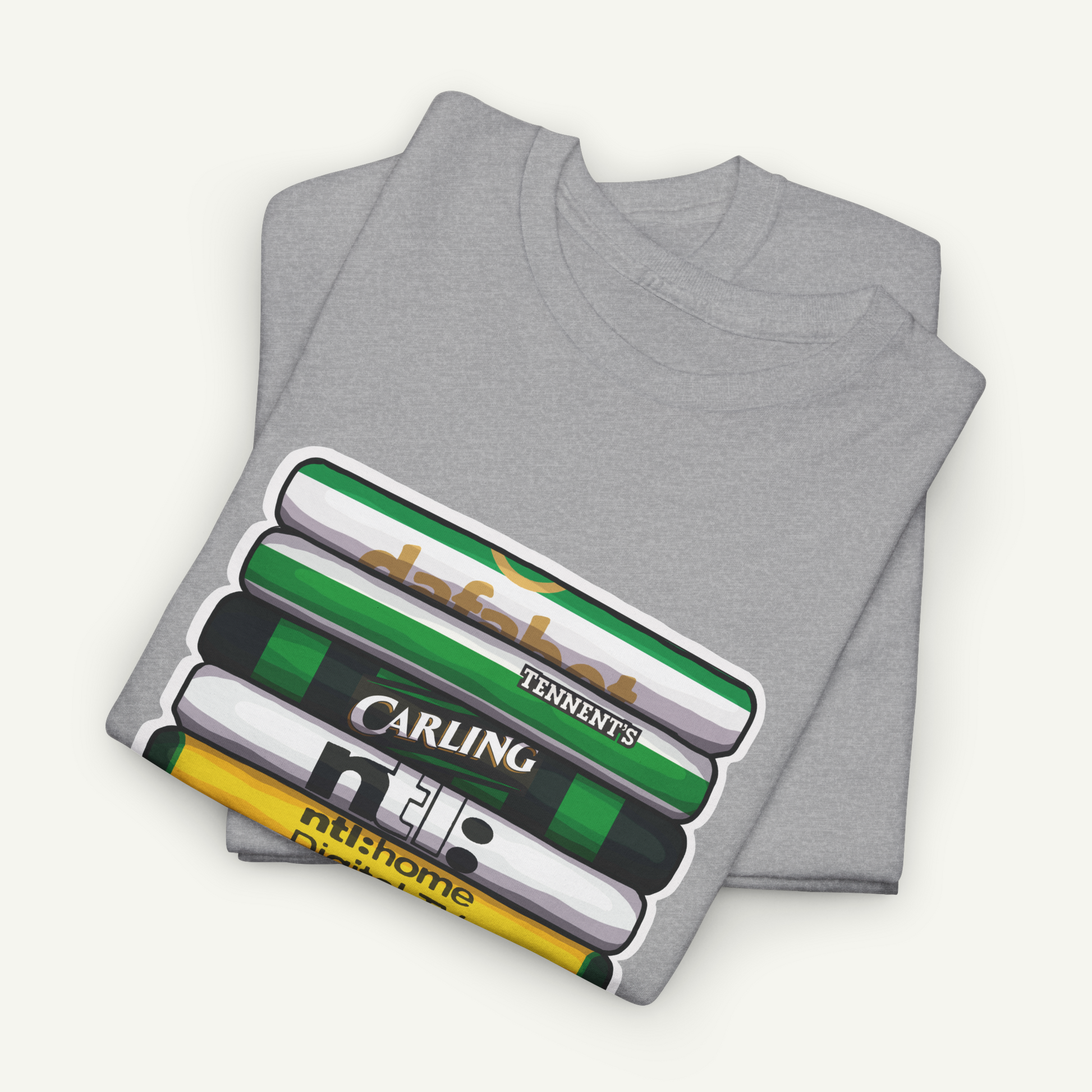 A gray t-shirt with a graphic design depicting a stack of books or magazines with various text and logos on the covers.