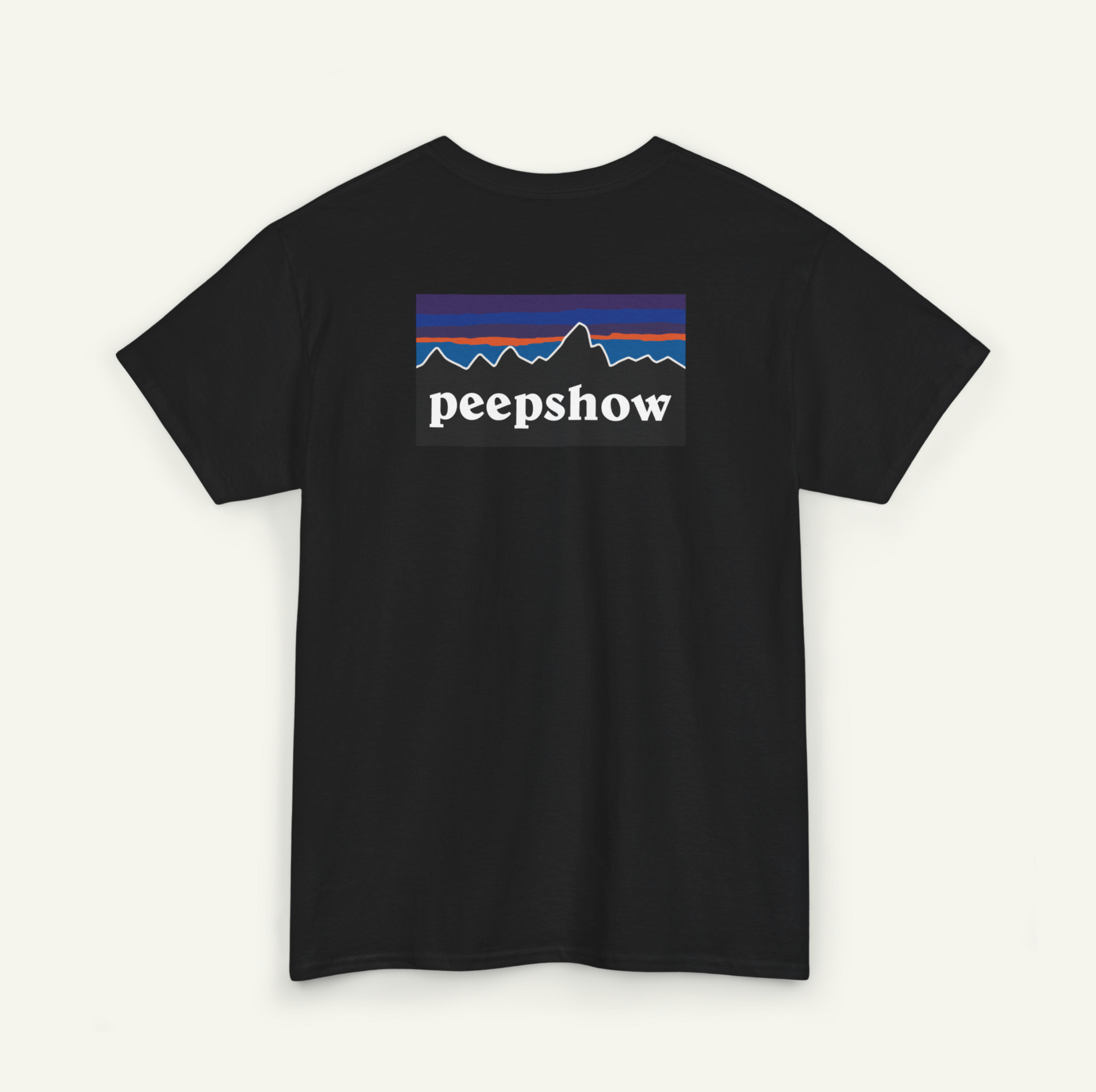 A black t-shirt with a graphic design featuring a mountain range and the text "peepshow" printed on it.