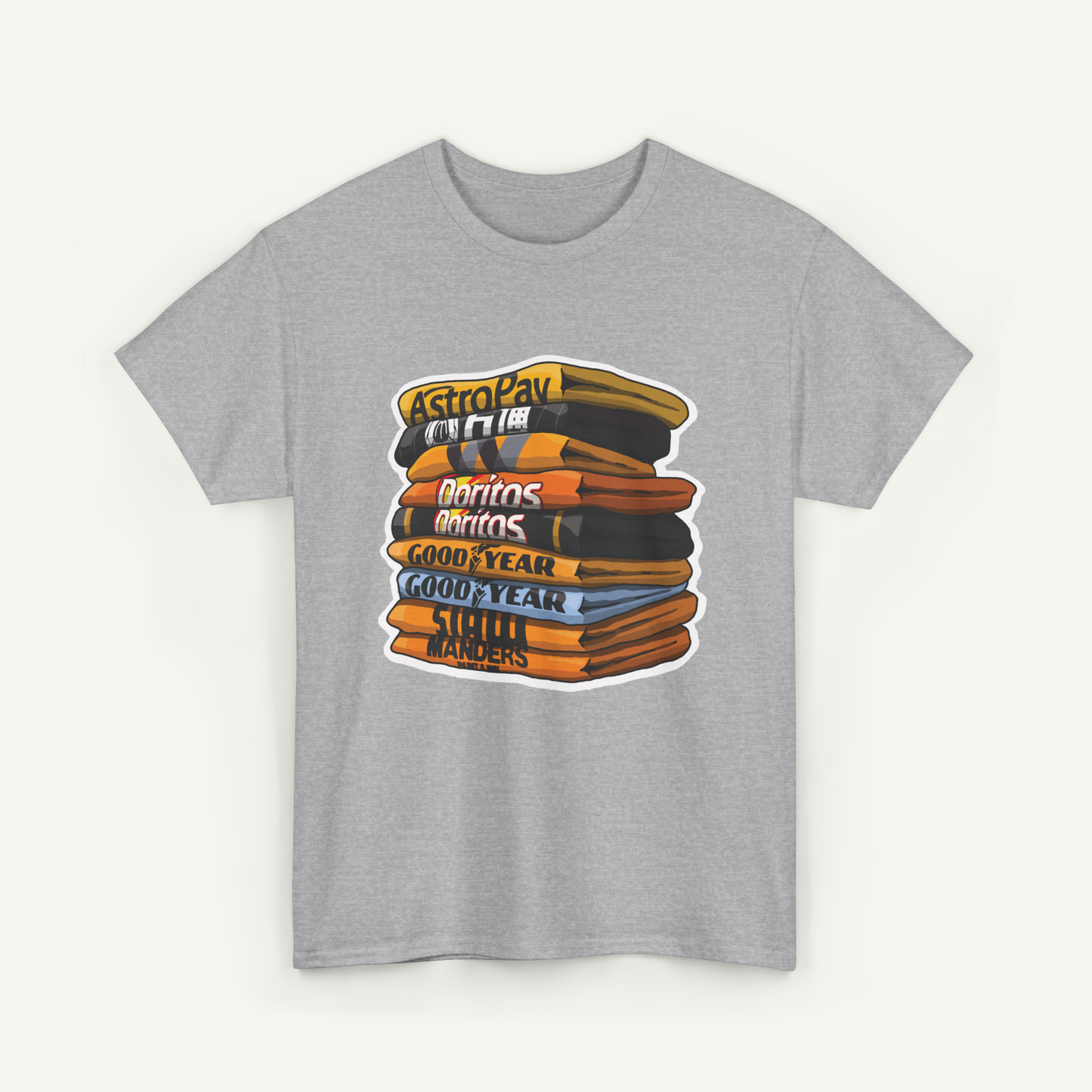 A gray t-shirt with a graphic design depicting a stack of colorful books or magazines with various titles written on them.