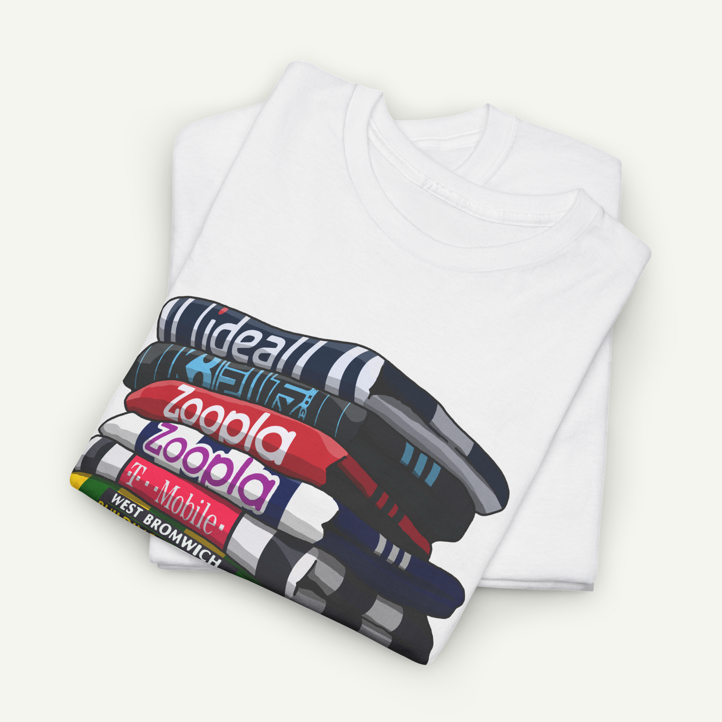 A white t-shirt with a graphic design depicting a stack of colorful books or magazines.