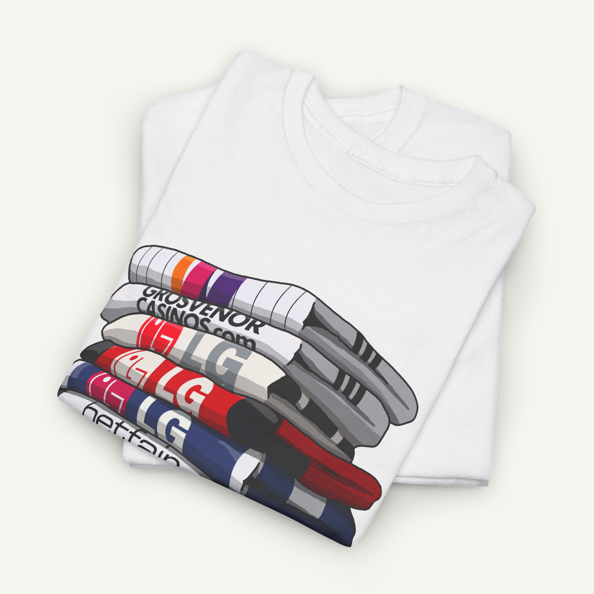 A white t-shirt with a graphic design depicting a stack of colorful books or magazines.