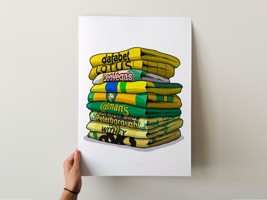 A hand is holding a poster with a stack of colorful towels, each with a different text or logo on it.