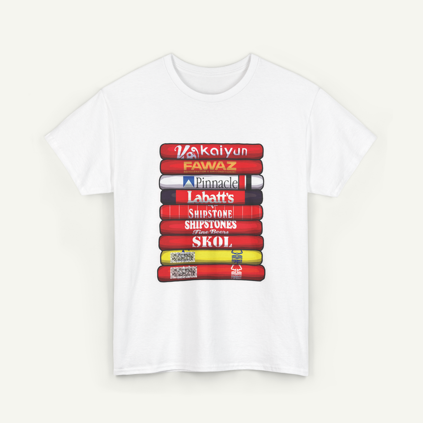 A white t-shirt with a graphic design depicting a stack of colorful books or magazines with various text titles on the spines.