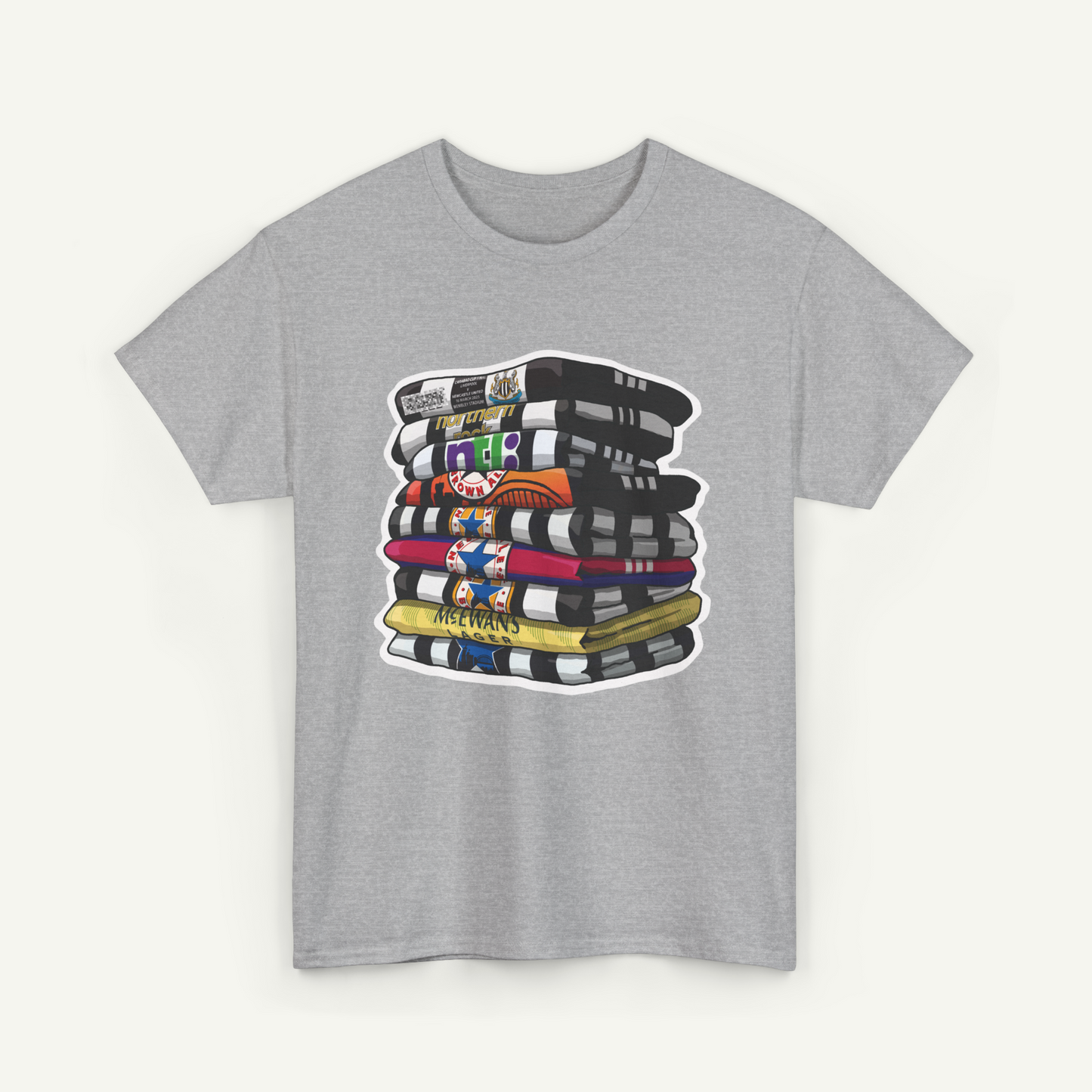 A gray t-shirt with a graphic design depicting a stack of colorful books or magazines.