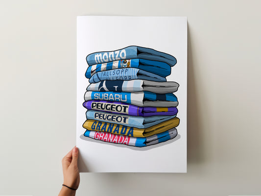 A hand is holding a poster with a stack of folded towels, each towel displaying a different car brand name.