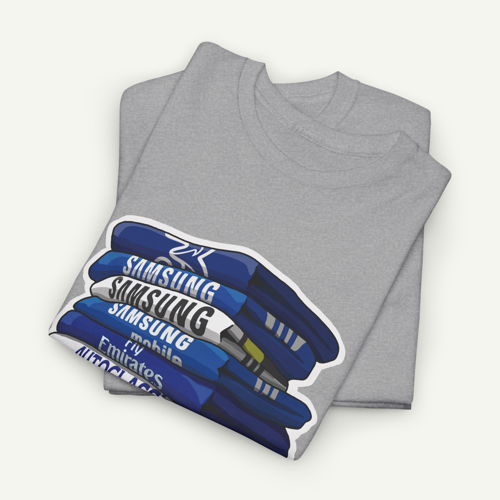 A gray t-shirt with a graphic design depicting a stack of blue and white books or magazines, with the text "Samsung Mobile" printed on the cover.