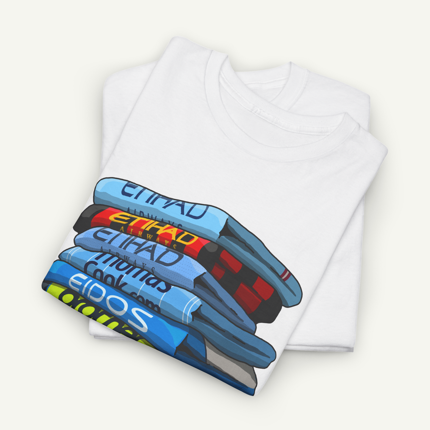 A white t-shirt with a colorful graphic design depicting a stack of books or magazines.