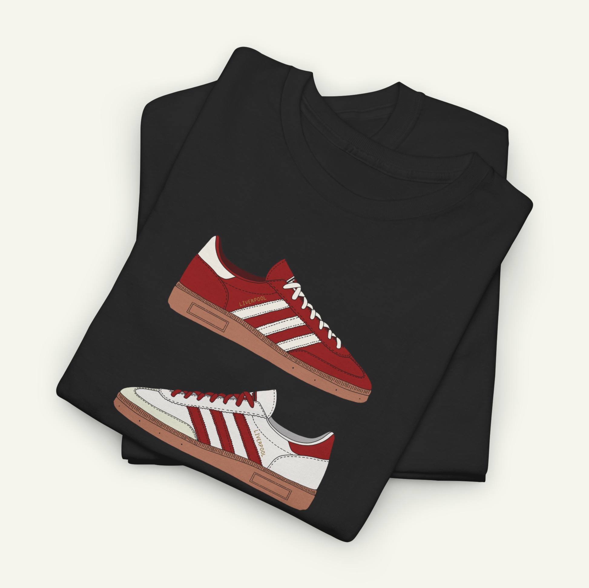 A black t-shirt with a graphic design of red and white Adidas sneakers printed on it.