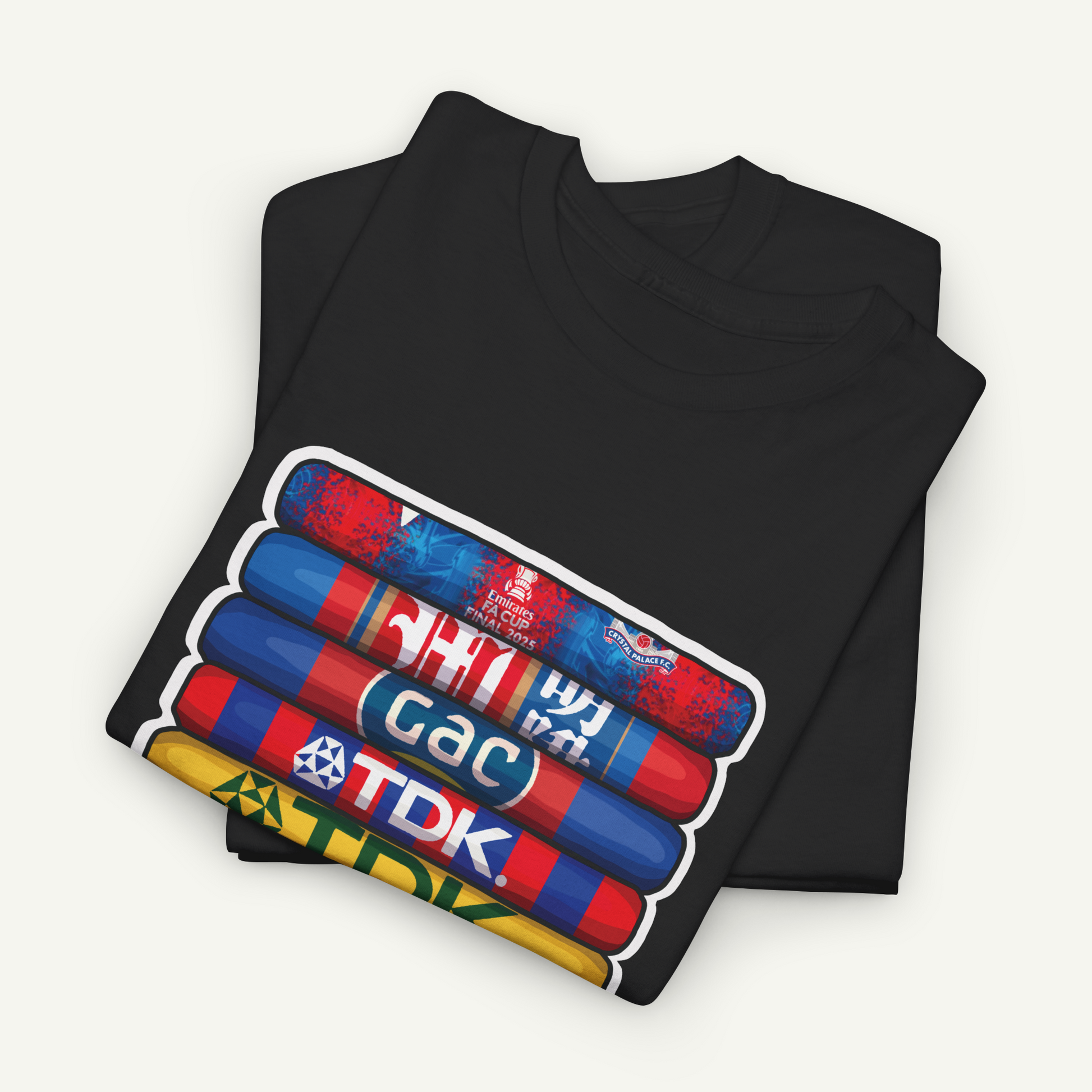 A black t-shirt with a colorful graphic design depicting a stack of colorful tubes or bottles with text on them.