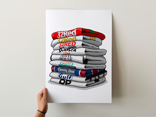A hand is holding a poster with a stack of books or magazines, each with a different logo or text on the cover.