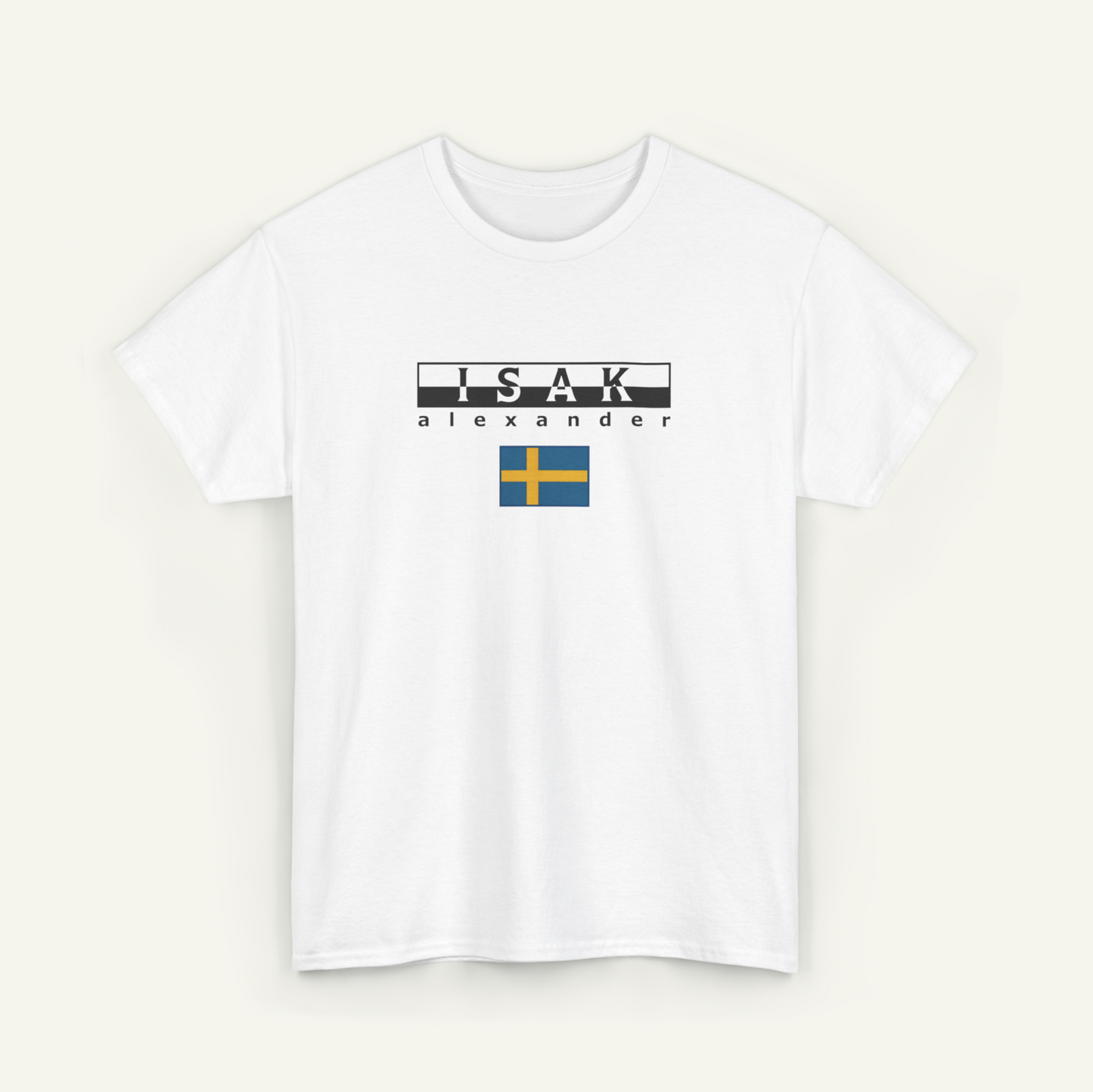 A white t-shirt with the text "ISAAK Alexander" printed on it, along with a small flag below the text.