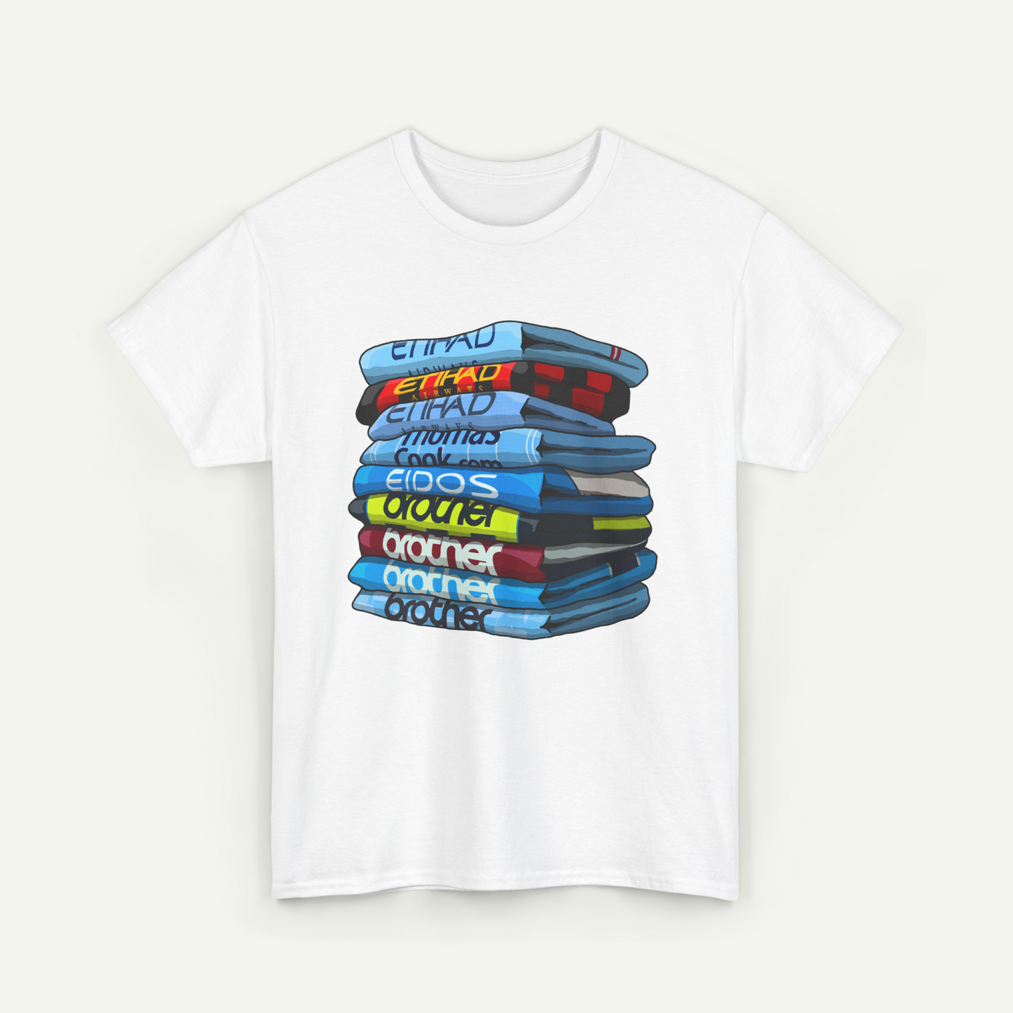 A white t-shirt with a graphic design depicting a stack of colorful books or magazines.