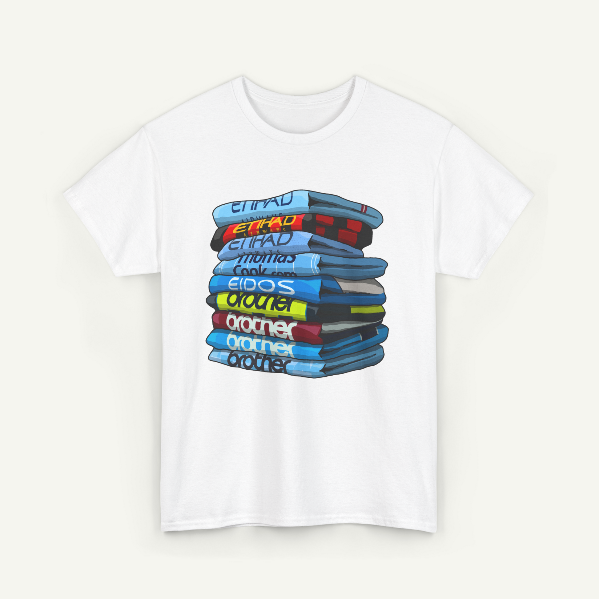 A white t-shirt with a graphic design depicting a stack of colorful books or magazines.
