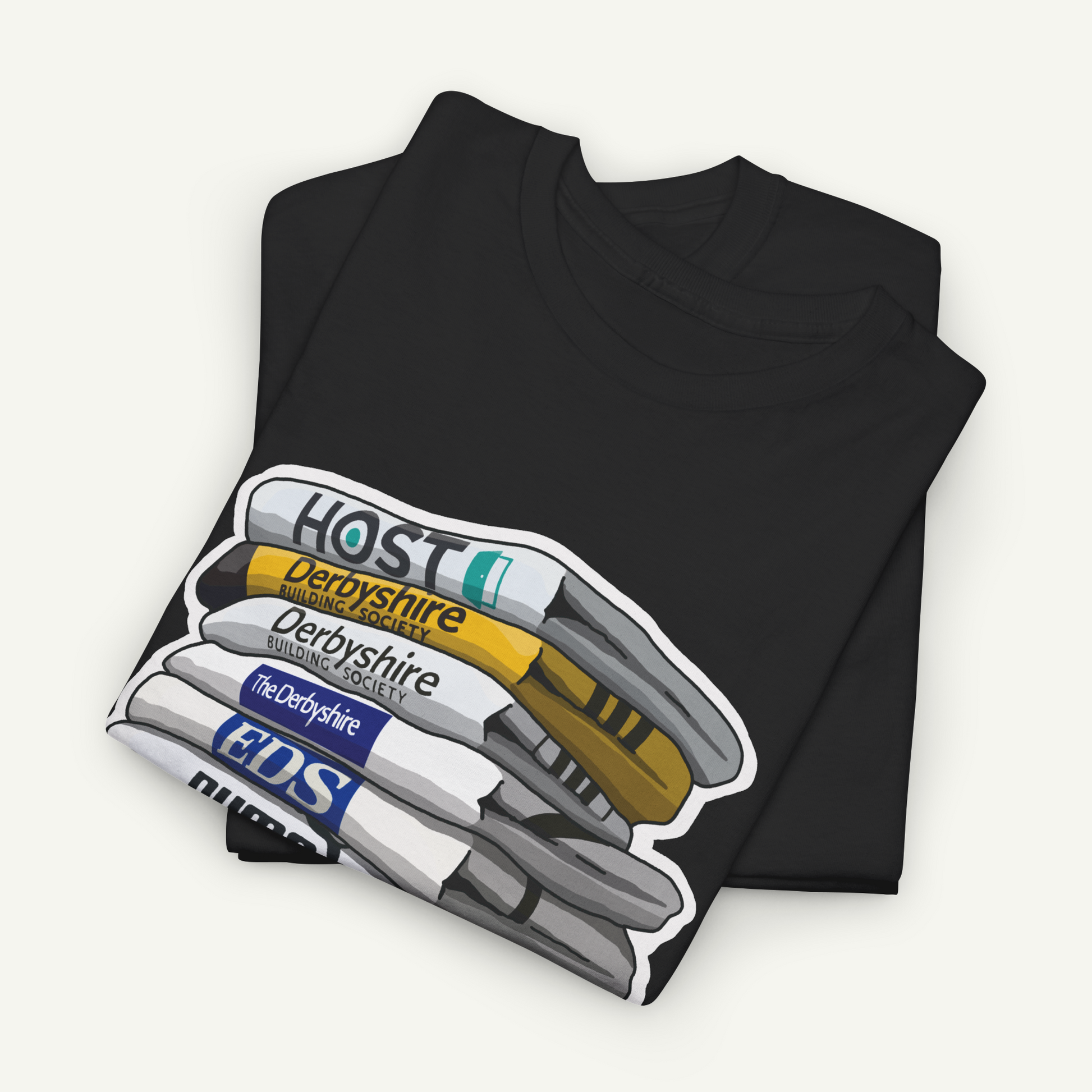 A black t-shirt with a graphic design depicting a stack of pens in various colors, including yellow, white, and blue.