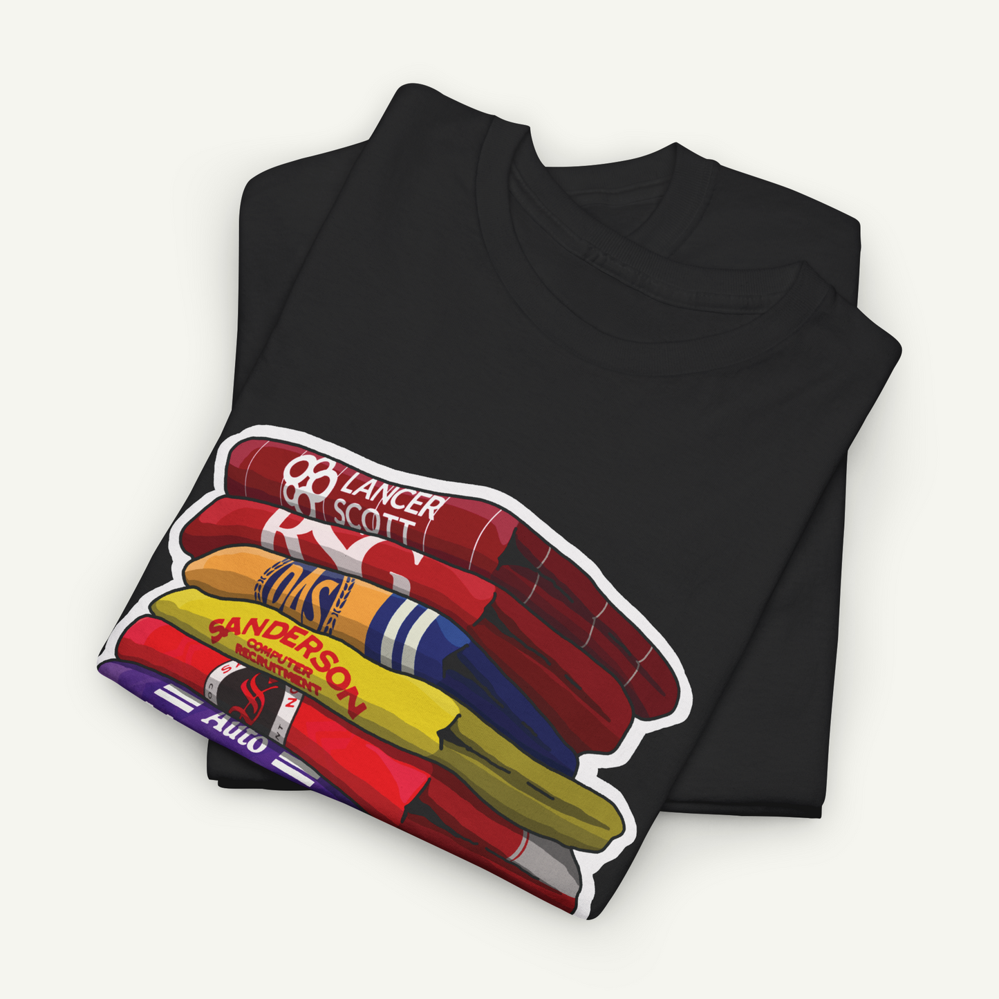 A black t-shirt with a colorful graphic design depicting a stack of various colored objects, including a red and white striped object, a yellow and blue striped object, and a red and white striped object.