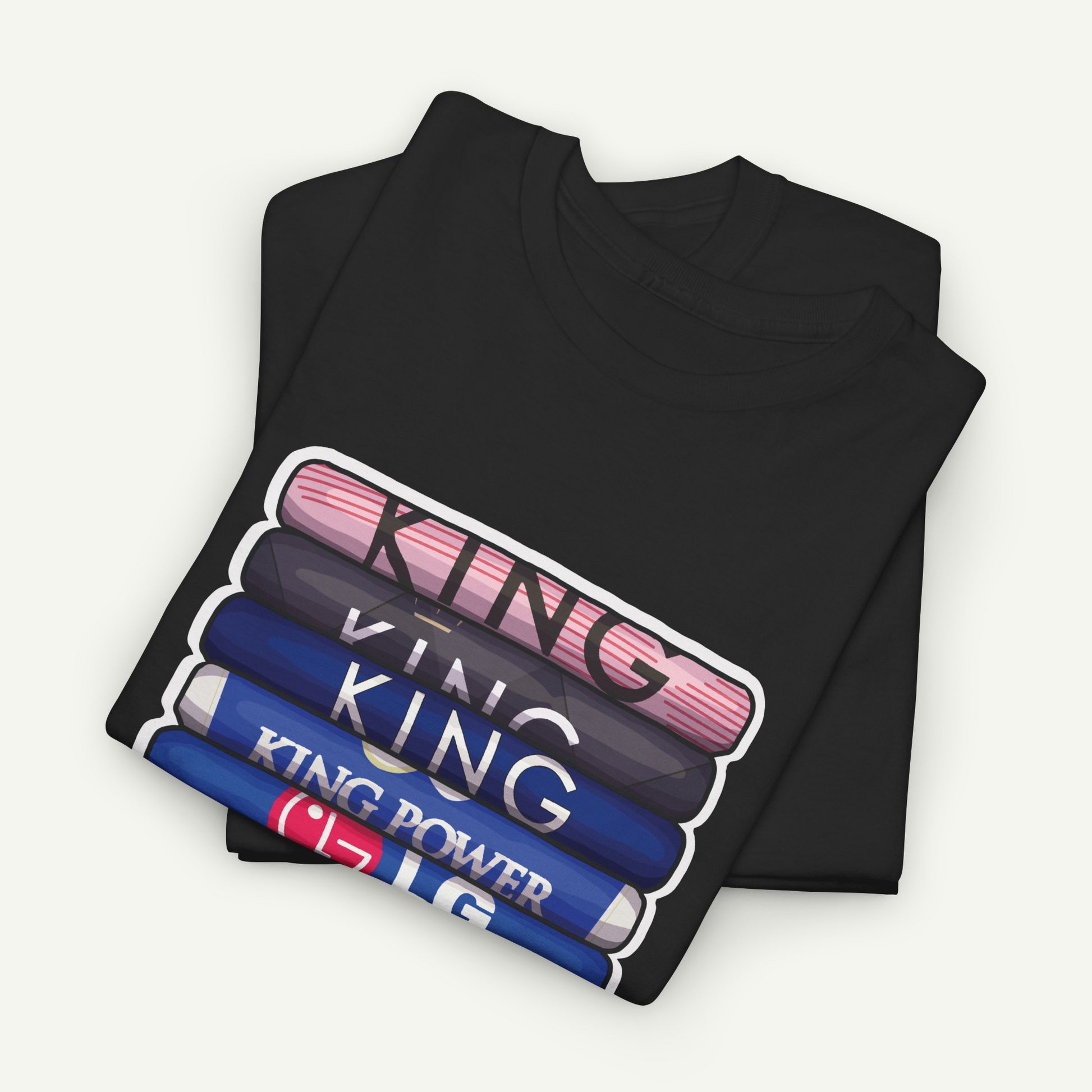 A black t-shirt with a graphic design featuring the text "KING" in a stacked arrangement, with each word in a different color.