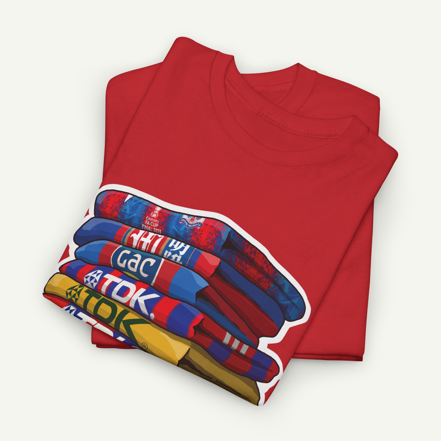 A red t-shirt with a colorful graphic design depicting a stack of books or magazines.