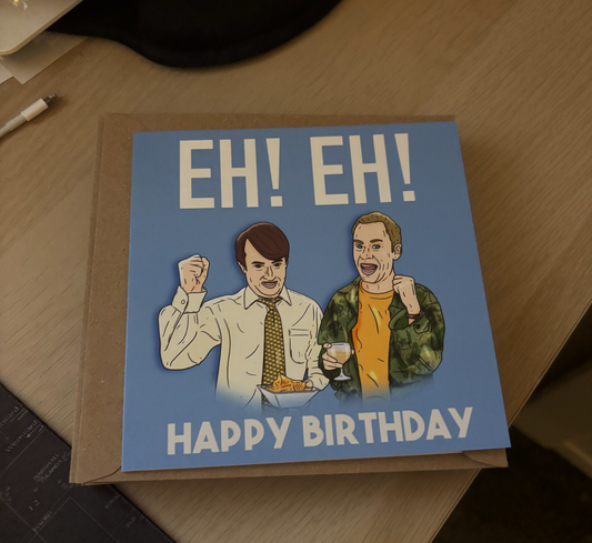 The image is a birthday card with a cartoon illustration of two men, one wearing a tie and the other wearing a jacket. The text on the card reads "EH! EH! HAPPY BIRTHDAY".
