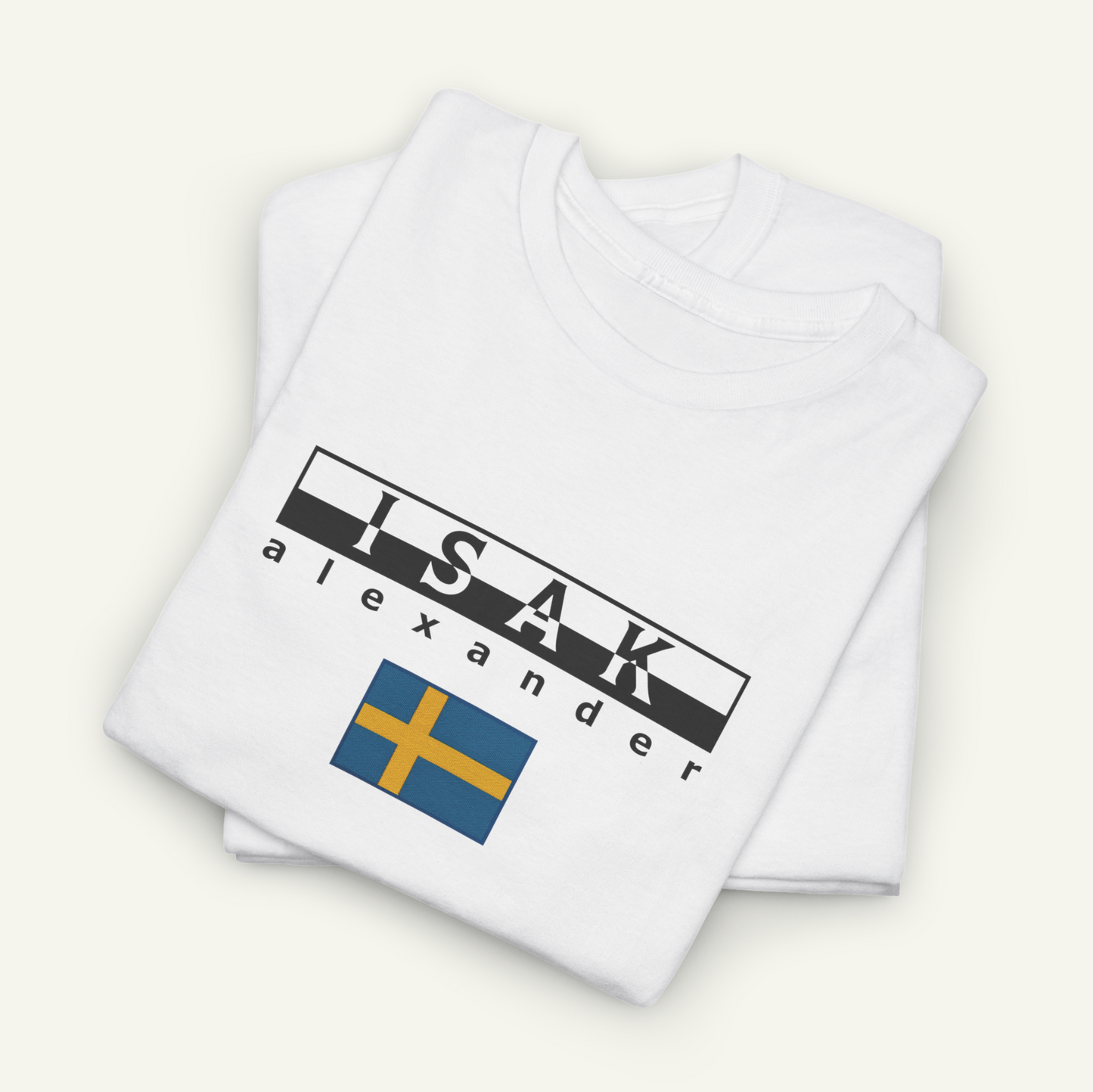 A white t-shirt with the text "ISAK Alexander" printed on it, along with a small flag design.