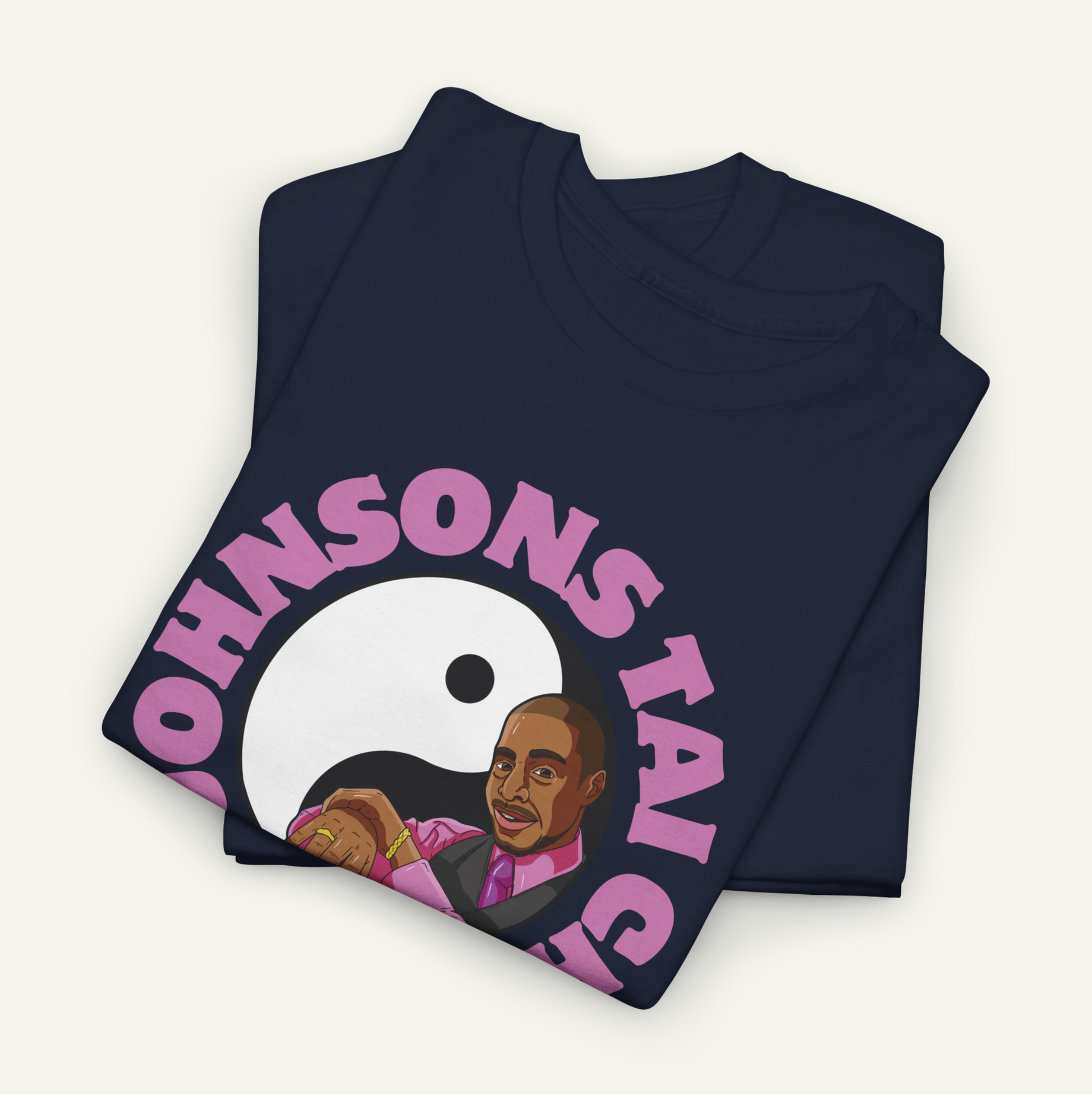 a dark blue t-shirt with a graphic design depicting a man wearing a suit and tie, with the text "OHNSON'S TAI" printed on it.